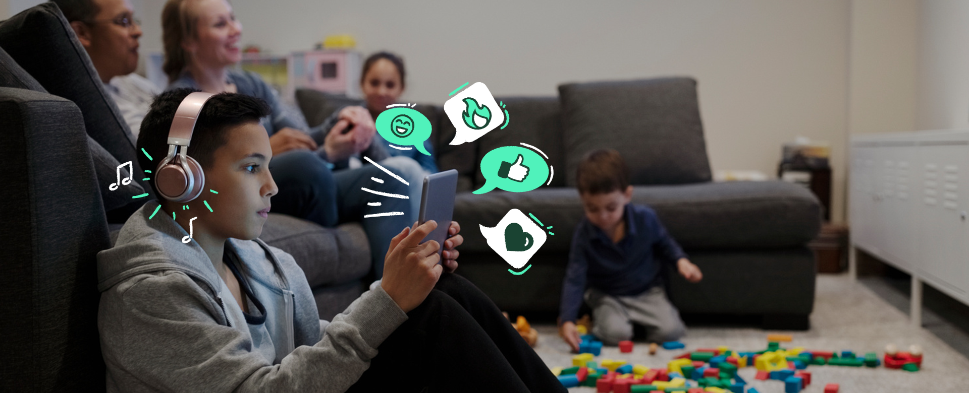 Young person on tablet surrounded by family