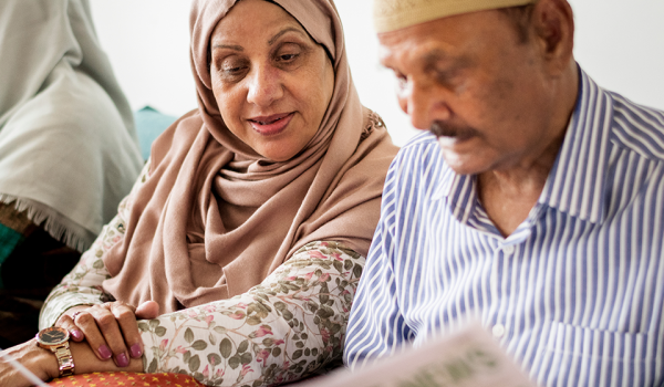 Husband and wife reading newspaper